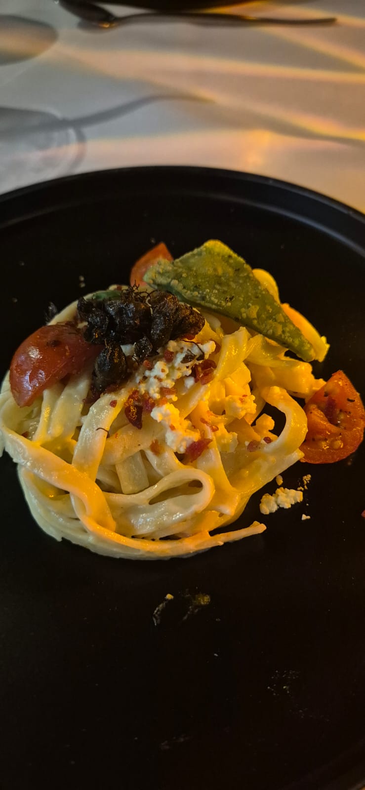 Fresh pasta on dark plate